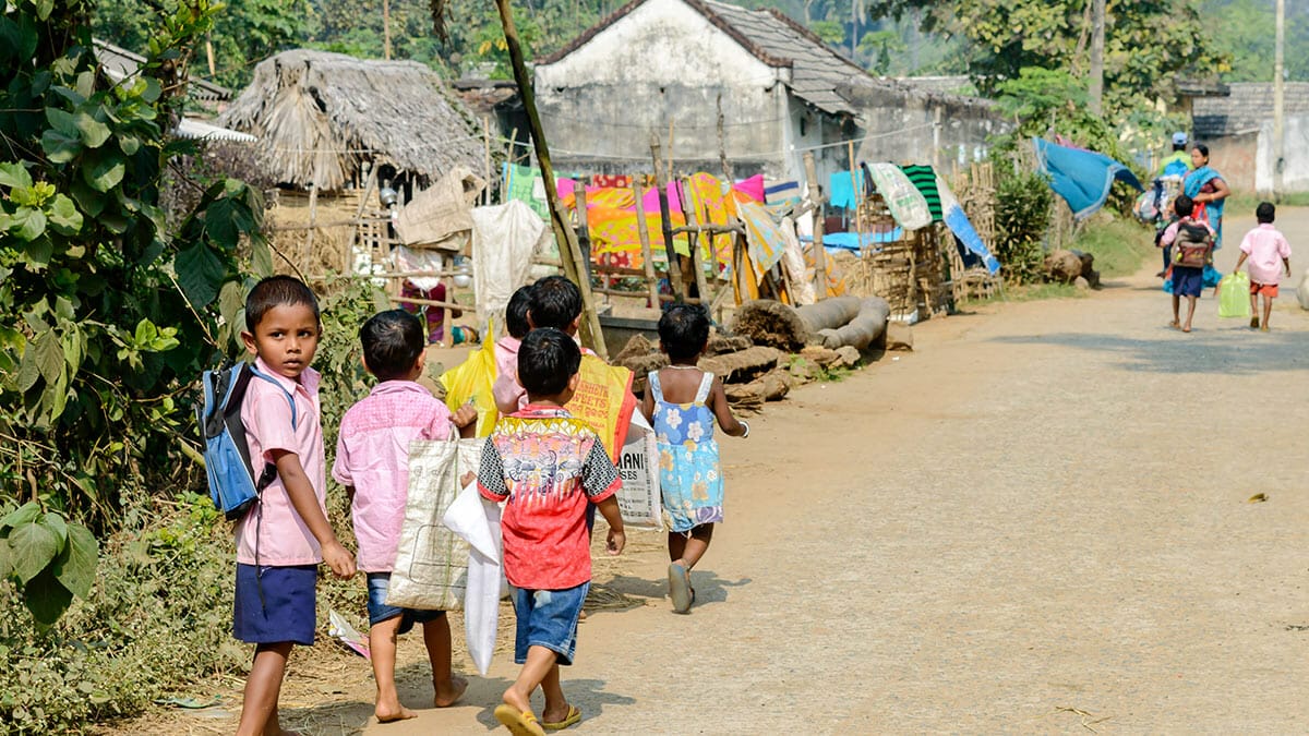 School children walking in a village after school in Angul district of Odisha state in india. Image: Abhishek Bagrodia / Shutterstock.com